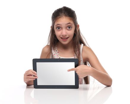 Beautiful pre-teen girl showing a tablet computer. Clipping path for the screen