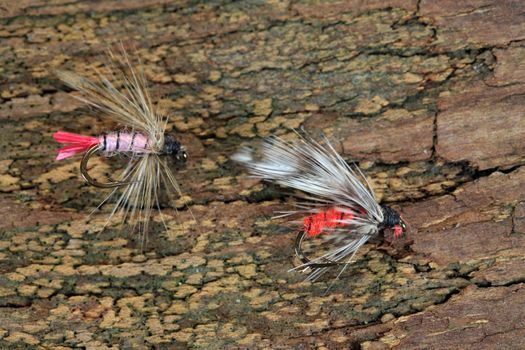 Macro photo of an artificial fly for fly fishing on a wood background. 