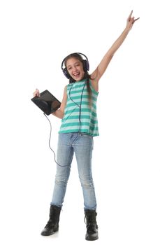 Beautiful pre-teen girl dancing and going crazy using a tablet computer and headphones