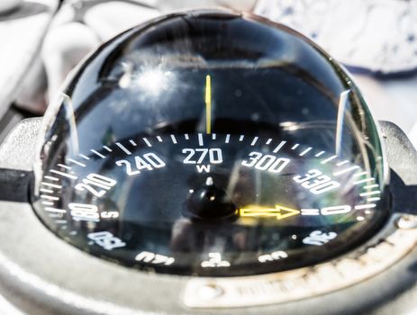 Sailing boat compass helm station with reflections