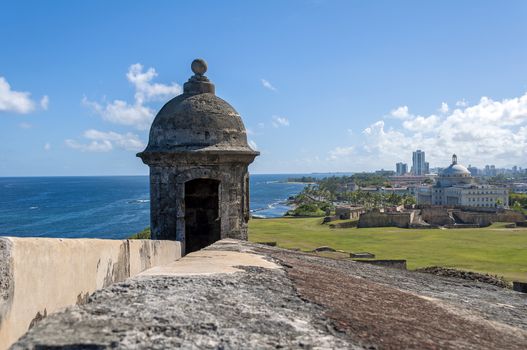 Observation tower at the Castillo de San Cristobal, with Capitol building in the background, San Juan, Puerto Rico.