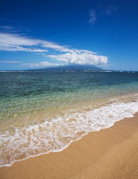 View of Maui in clouds from Molokai Beach