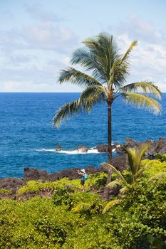 Tourist taking photo near Hana on Maui