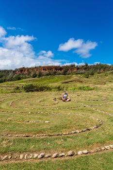 Woman meditating in labyrinth near Dragon's Teeth