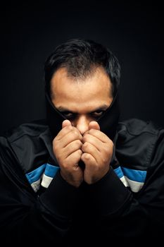 Close up portrait of a mysterious man with face covered by jacket