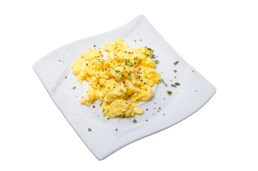 Scrambled eggs, exempted white plate with parsley.