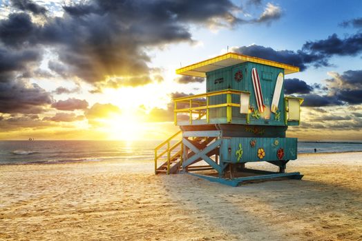 Miami South Beach sunrise with lifeguard tower and coastline with colorful cloud and blue sky. 
