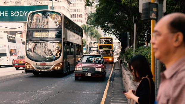 People waiting for the bus at bus stop in Hongkong street