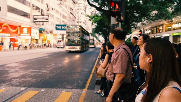People waiting for the bus at bus stop in Hongkong street