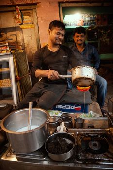 An Indian tea vendor preparing tea, CNB, Kanpur, India.