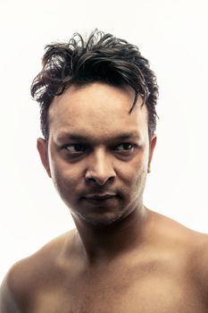 Portrait of handsome indian young man over white background