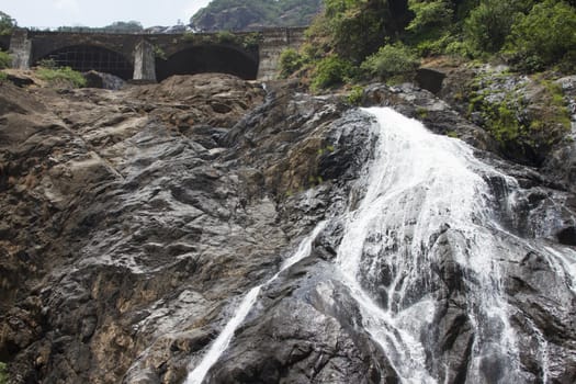 Waterfall in the jungle, a beautiful view of the railway on  cliff .Indiya Goa.