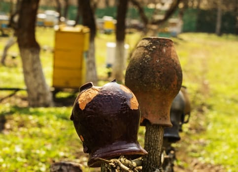 Old traditional clay jug hanging on the wooden fence