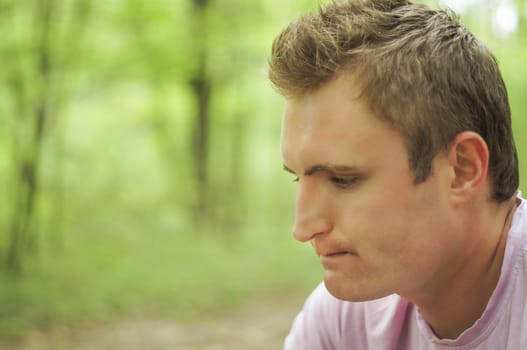 Thoughtful young man Outdoors. For your commercial and editorial use.