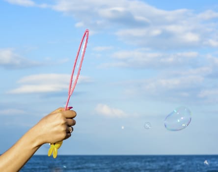 Colorful Soap Bubbles Against Blue Sky Background. For your commercial and editorial use.