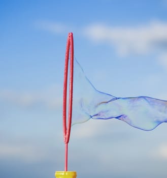 Colorful Soap Bubbles Against Blue Sky Background. For your commercial and editorial use.