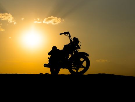 Silhouette of a motorcycl on a background of dark sky