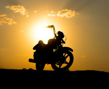 Silhouette of a motorcycl on a background of dark sky. For your commercial and editorial use.