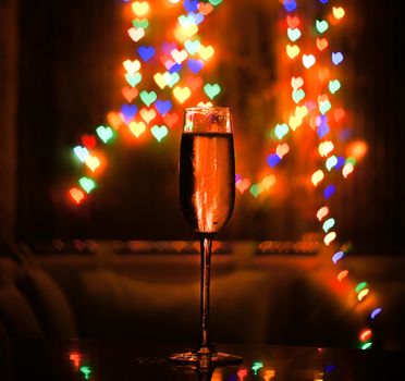 A glass of champagne on the background bokeh. For your commercial and editorial use.