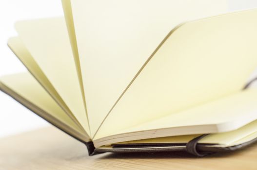 open book with the incident light from the side on desk.