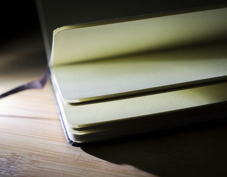 open book with the incident light from the side on desk.