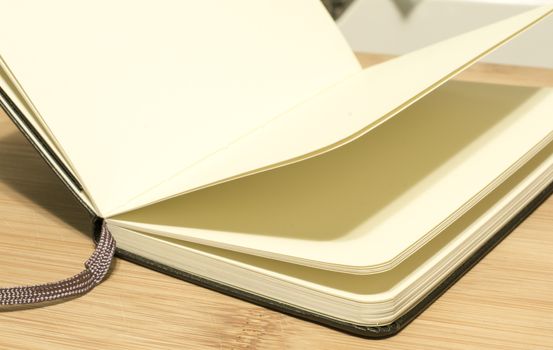 open book with the incident light from the side on desk.