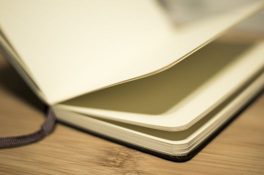 open book with the incident light from the side on desk.