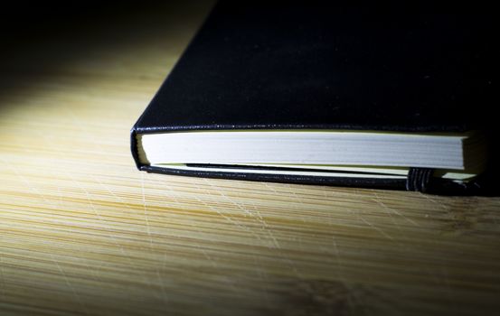 open book with the incident light from the side on desk.