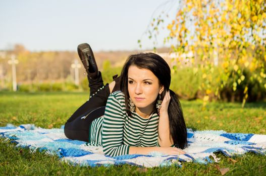 beautiful and sexy girl sitting on bench outdoors. 