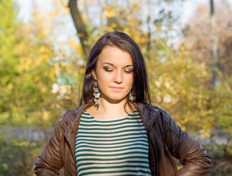 beautiful and sexy girl sitting on bench outdoors. 