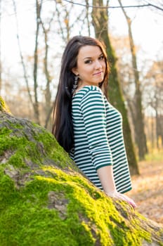 beautiful and sexy girl sitting on bench outdoors. 