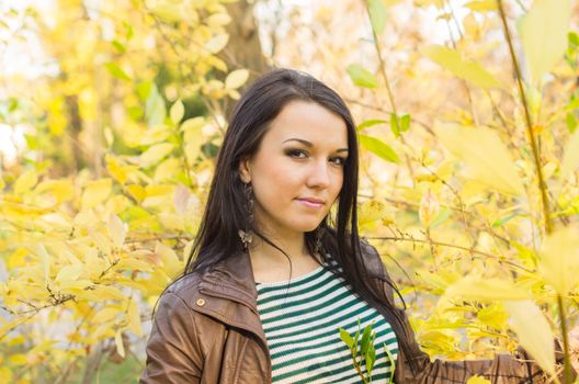 beautiful and sexy girl sitting on bench outdoors. 