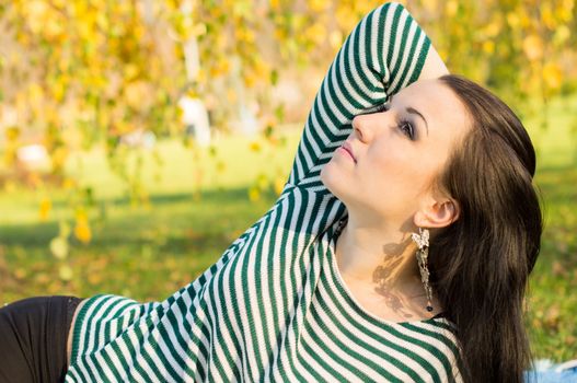 beautiful and sexy girl sitting on bench outdoors. 