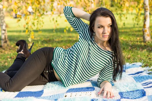 beautiful and sexy girl sitting on bench outdoors. 