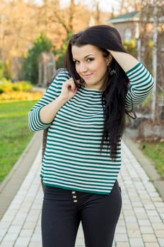 beautiful and sexy girl sitting on bench outdoors. 