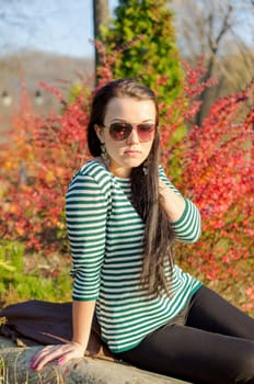 beautiful and sexy girl sitting on bench outdoors. 