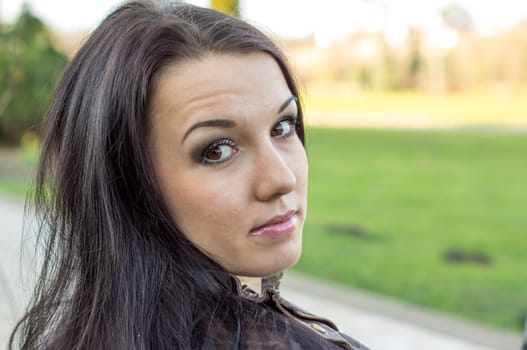 beautiful and sexy girl sitting on bench outdoors. 