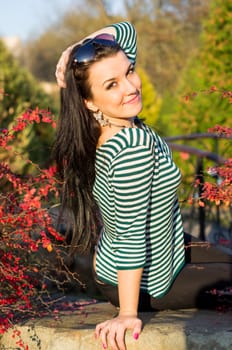 beautiful and sexy girl sitting on bench outdoors. 