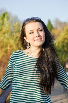 beautiful and sexy girl sitting on bench outdoors. 