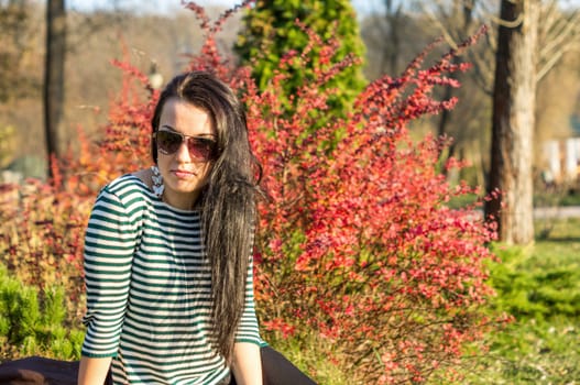 beautiful and sexy girl sitting on bench outdoors. 