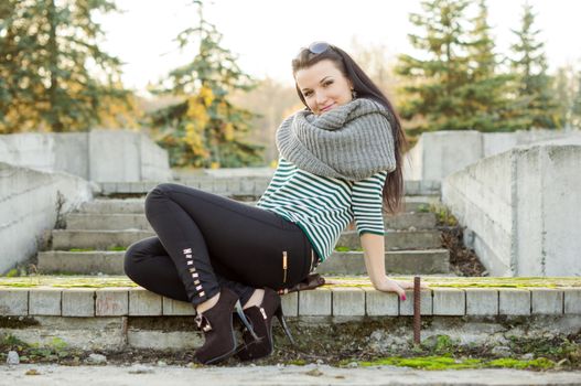 beautiful and sexy girl sitting on bench outdoors. 