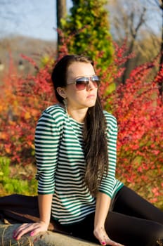 beautiful and sexy girl sitting on bench outdoors. 