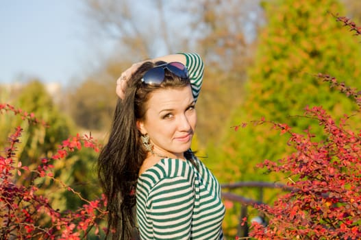 beautiful and sexy girl sitting on bench outdoors. 