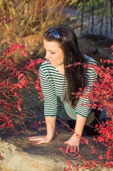 beautiful and sexy girl sitting on bench outdoors. 