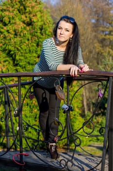 beautiful and sexy girl sitting on bench outdoors. 