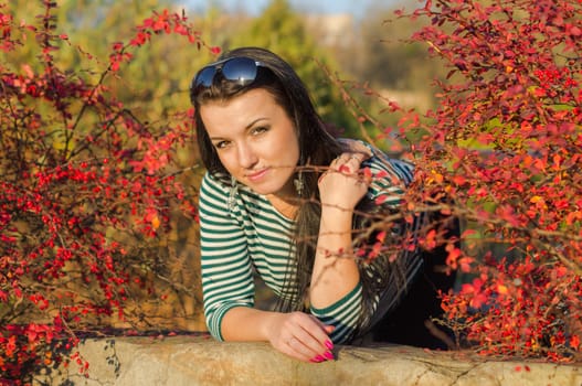 beautiful and sexy girl sitting on bench outdoors. 