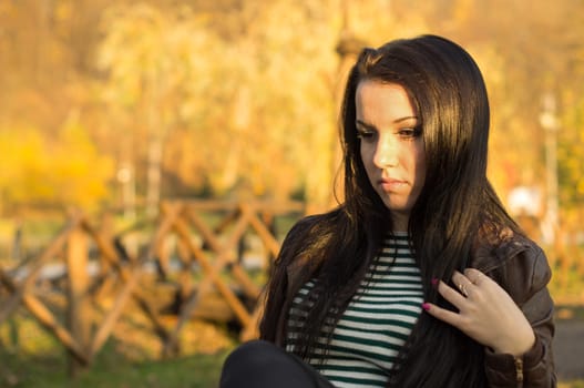 beautiful and sexy girl sitting on bench outdoors. 