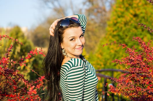 beautiful and sexy girl sitting on bench outdoors. 