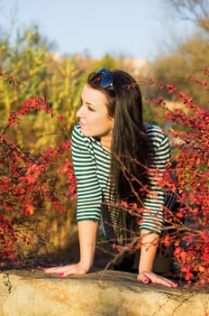 beautiful and sexy girl sitting on bench outdoors. 