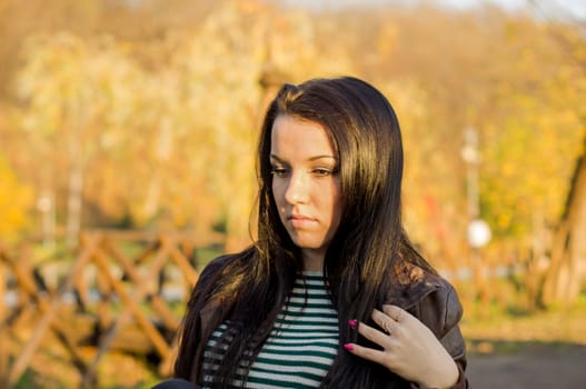 beautiful and sexy girl sitting on bench outdoors. 